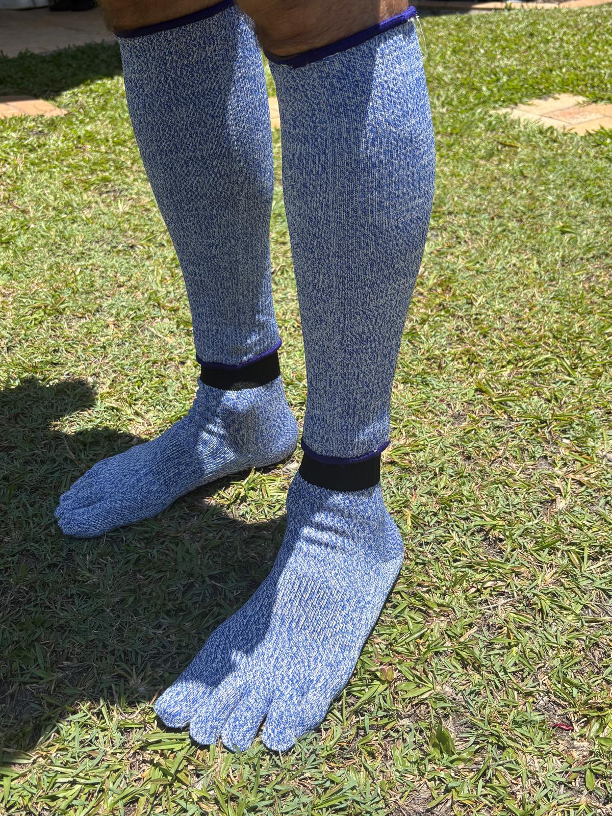 Blue toe-toe socks worn on grass