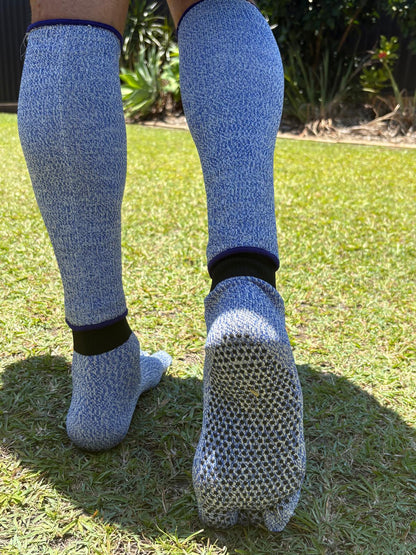 Person wearing blue textured socks on grass