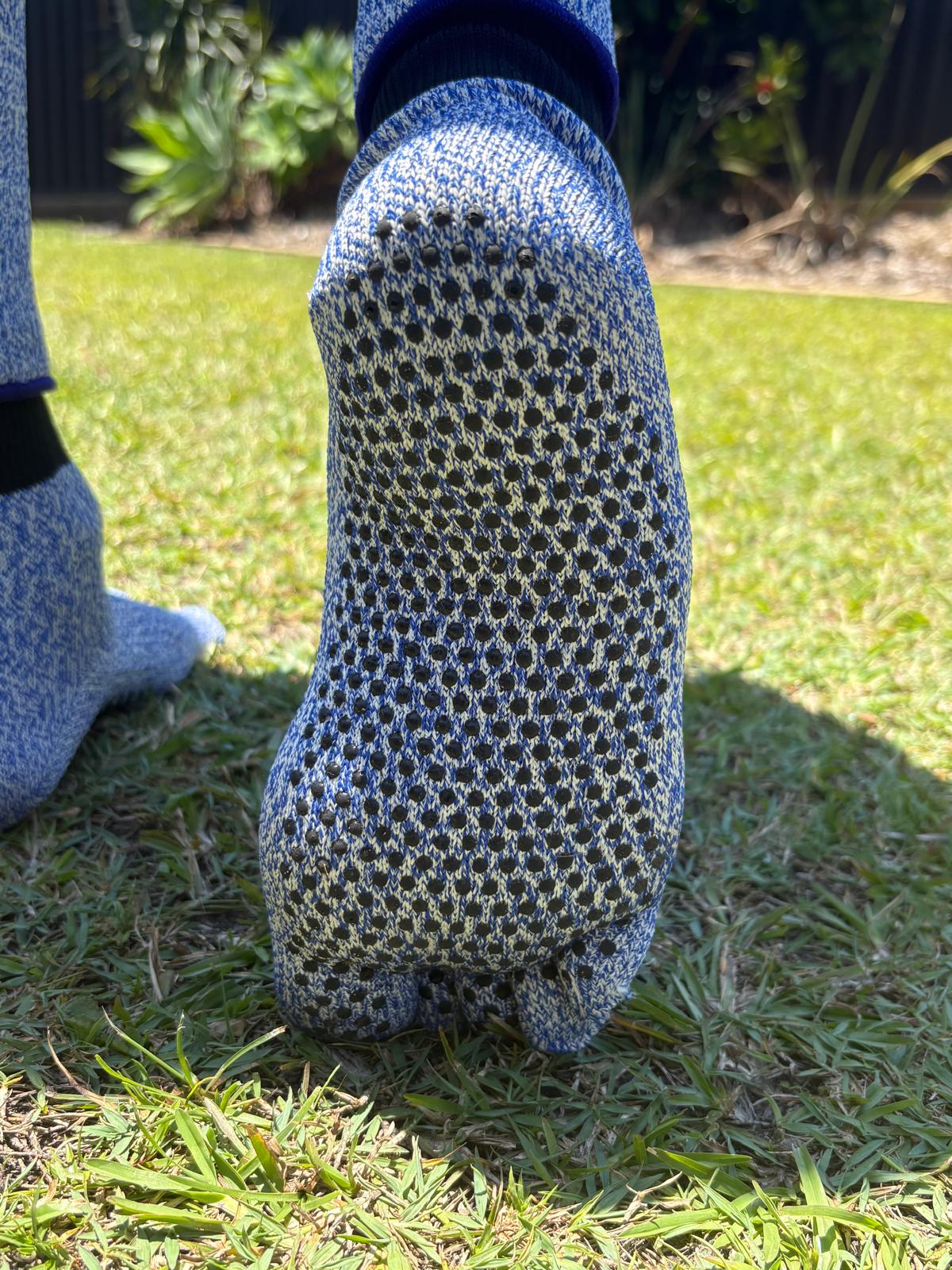 Person wearing blue textured socks on grass