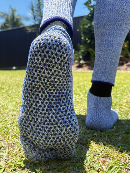 Close-up of blue textured socks on grass