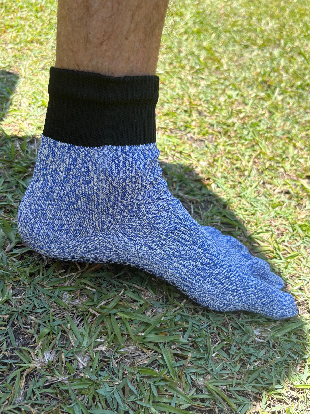 Blue sock with black top on a grassy background