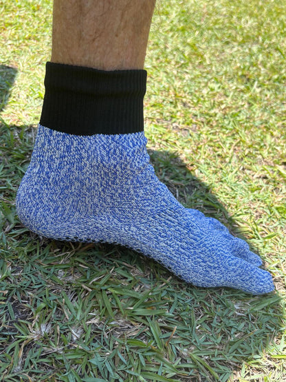Blue sock with black top on a grassy background